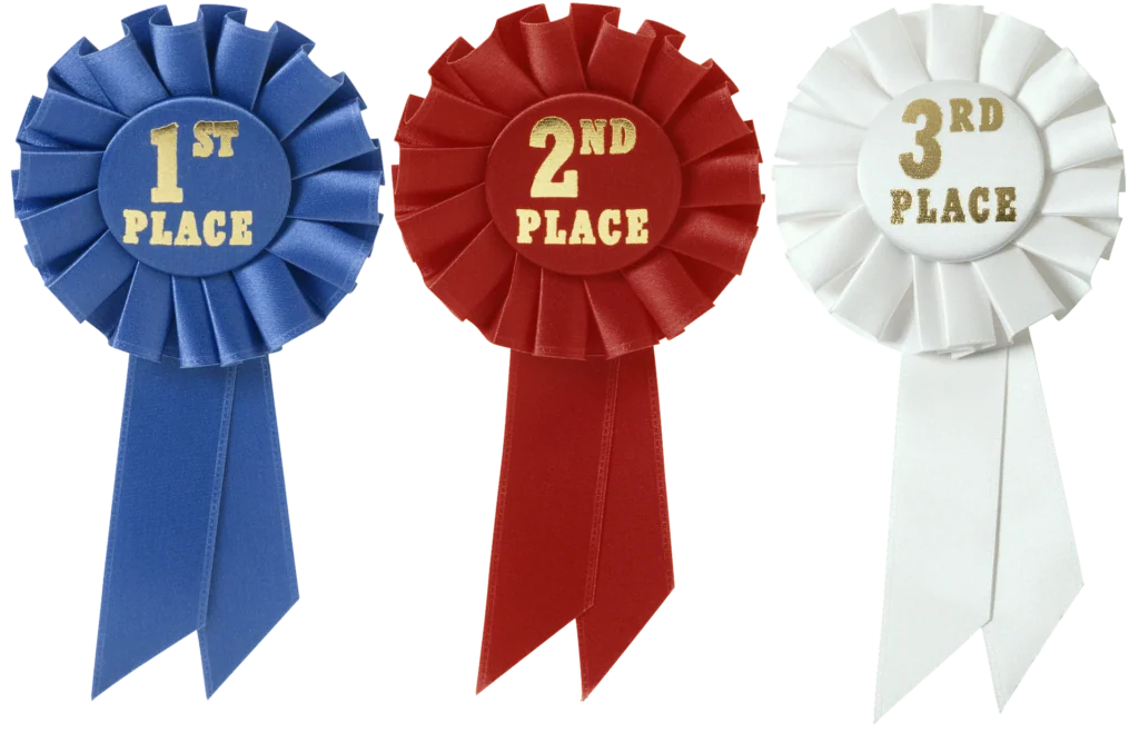 Three award ribbons in blue, red, and white labeled 1st, 2nd, and 3rd place with matching ribbons